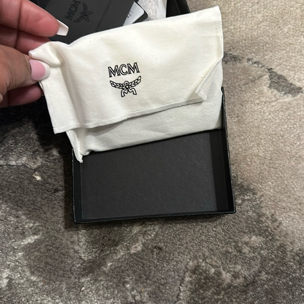MCM card holder. 4 slots & a middle section. New w/box and dust bag.